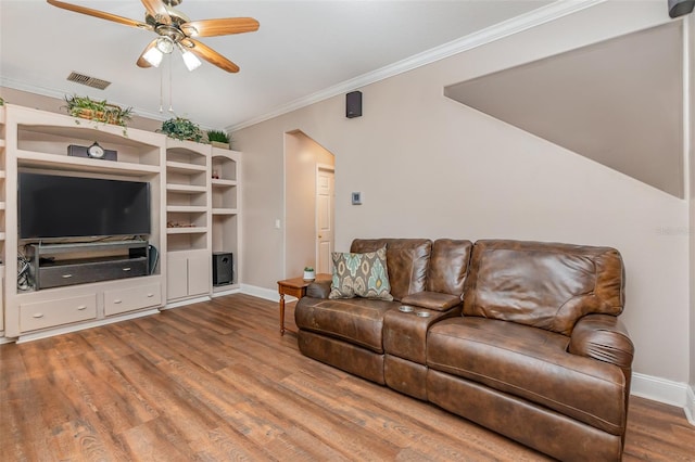 living room featuring ceiling fan, wood-type flooring, and crown molding