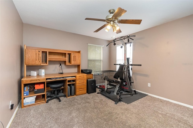 carpeted office featuring ceiling fan