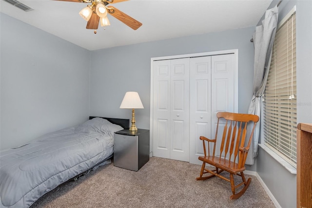 bedroom featuring ceiling fan, a closet, and light carpet