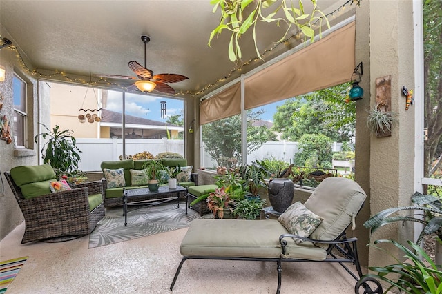 sunroom featuring ceiling fan