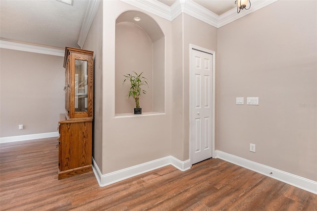 corridor with crown molding and hardwood / wood-style flooring