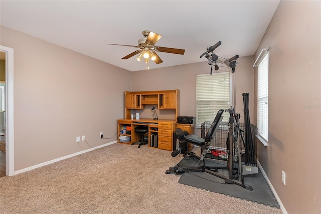 workout room featuring ceiling fan and light colored carpet