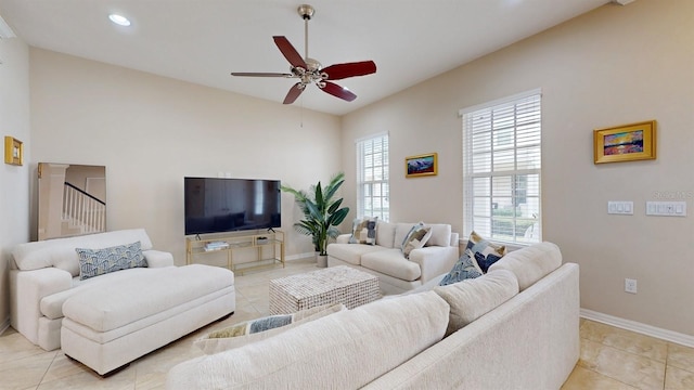 living room with light tile patterned floors and ceiling fan