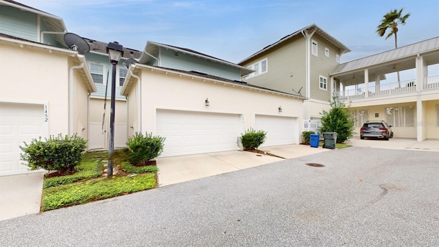 exterior space with a balcony and a garage