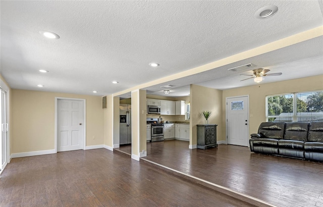 unfurnished living room with dark wood-type flooring, a textured ceiling, and ceiling fan