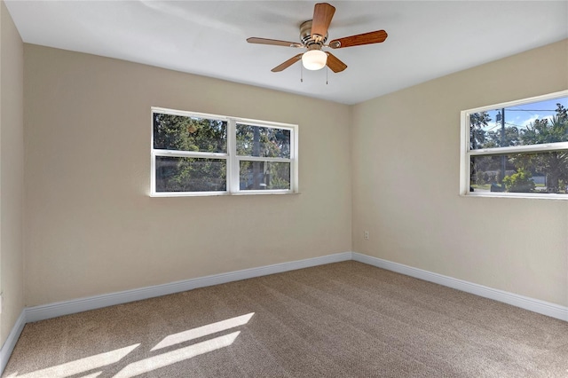 spare room featuring ceiling fan and carpet flooring