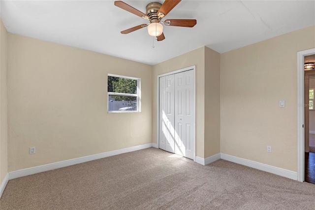 unfurnished bedroom with light carpet, ceiling fan, and a closet