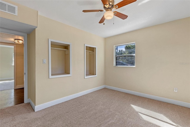 empty room featuring carpet and ceiling fan