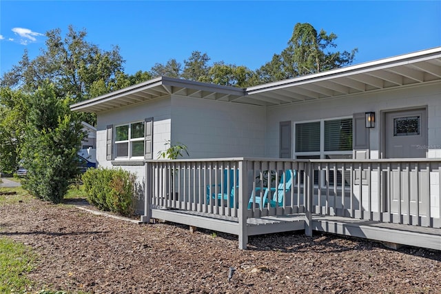 rear view of property with a wooden deck