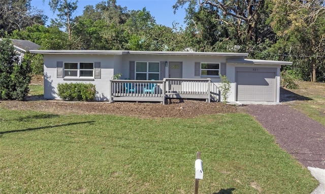 ranch-style home with a garage and a front yard