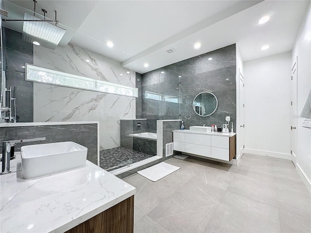 bathroom with vanity, tile walls, and tiled shower