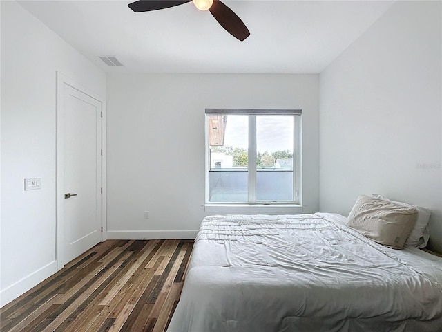 bedroom with dark wood-type flooring and ceiling fan