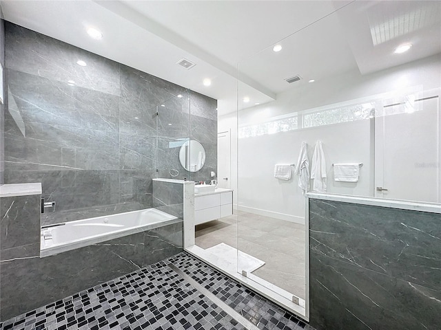 bathroom featuring vanity, tile patterned flooring, and plus walk in shower