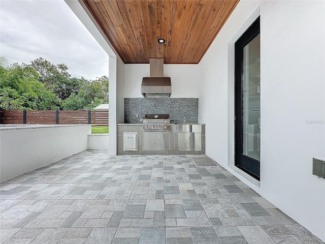 view of patio with an outdoor kitchen and a grill