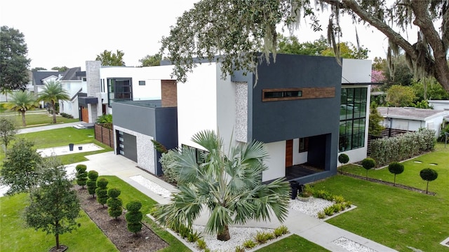 view of front of home featuring a garage and a front lawn