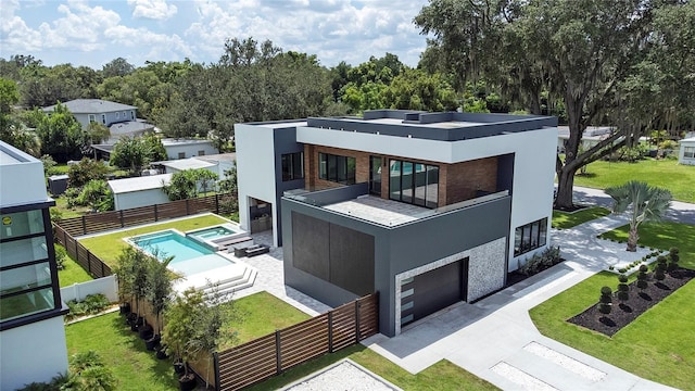 back of house featuring a patio, a balcony, a lawn, and a fenced in pool