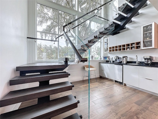 interior space with sink, wood-type flooring, and a wealth of natural light