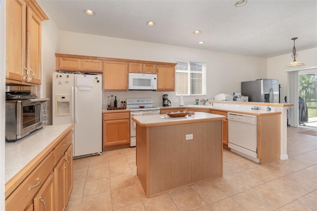 kitchen featuring light tile patterned flooring, a center island, pendant lighting, and white appliances