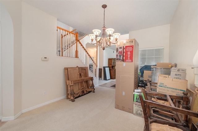 carpeted office space featuring a notable chandelier