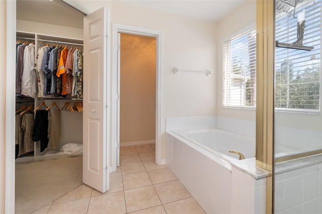 bathroom featuring tile patterned floors and a relaxing tiled tub