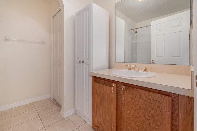 bathroom with vanity, a shower, and tile patterned flooring