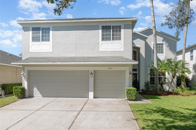 front of property featuring a garage and a front lawn