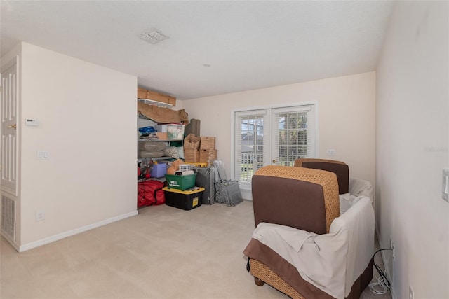 sitting room featuring light colored carpet