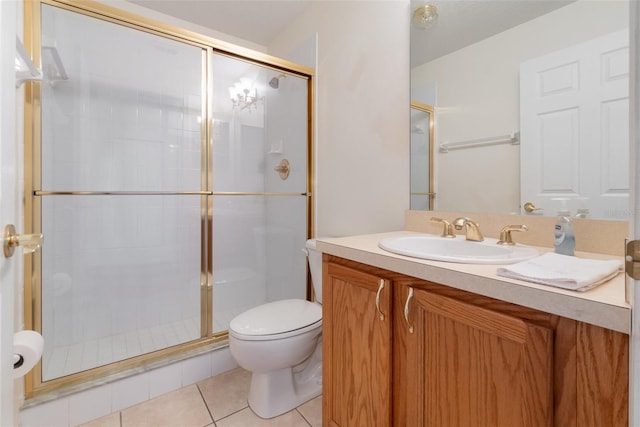 bathroom with vanity, an enclosed shower, toilet, and tile patterned flooring