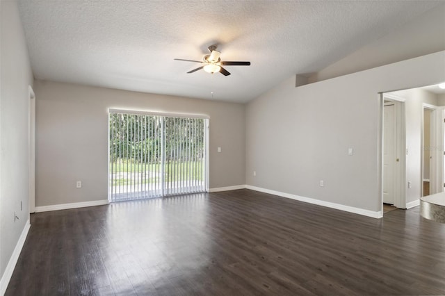 spare room featuring ceiling fan, vaulted ceiling, dark wood-type flooring, and a textured ceiling