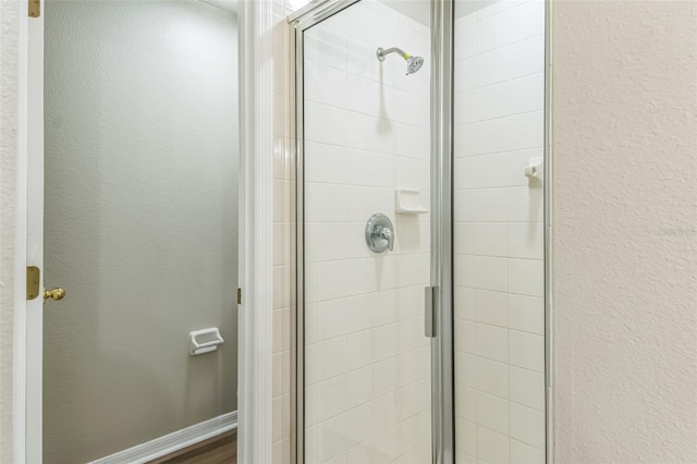 bathroom with a shower with shower door