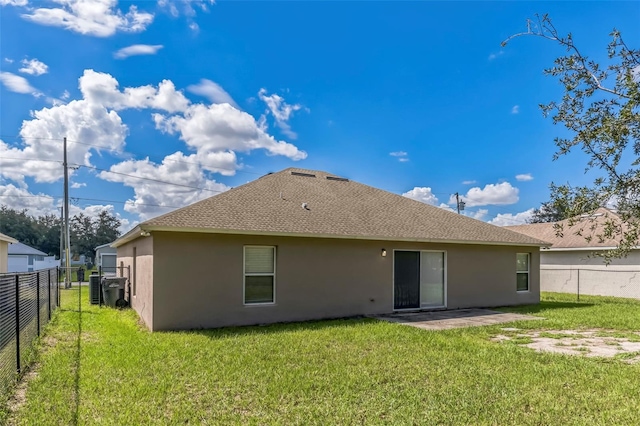 rear view of property with a lawn and a patio