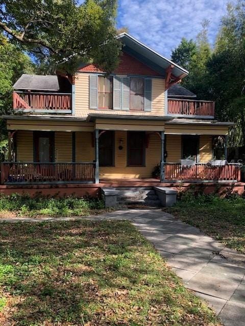 view of front of house featuring a porch and a balcony