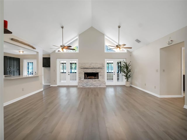 unfurnished living room with a wealth of natural light, french doors, and hardwood / wood-style floors