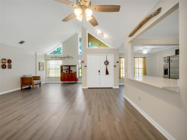 entryway with high vaulted ceiling, wood-type flooring, and ceiling fan