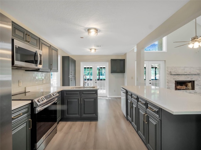 kitchen with french doors, a healthy amount of sunlight, appliances with stainless steel finishes, and sink