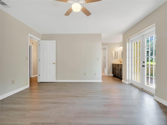 unfurnished room featuring french doors, light hardwood / wood-style floors, and ceiling fan