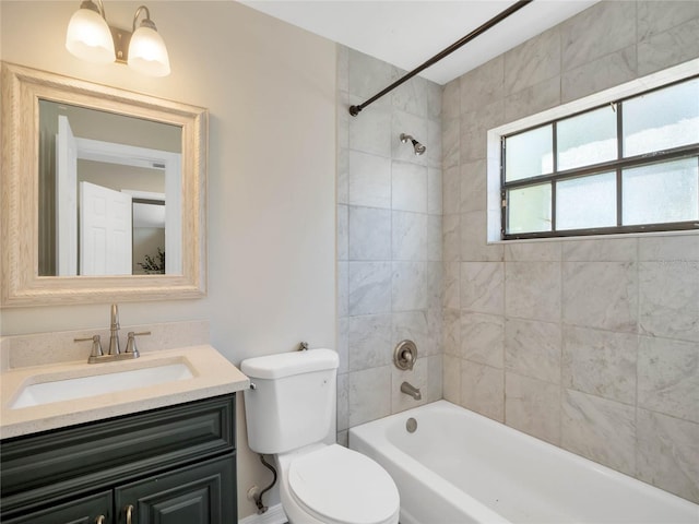 full bathroom featuring vanity, toilet, and tiled shower / bath combo