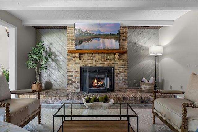 living room featuring hardwood / wood-style flooring, beam ceiling, wooden walls, a textured ceiling, and a fireplace