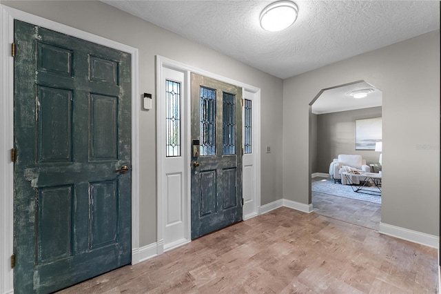 foyer featuring hardwood / wood-style flooring and a textured ceiling