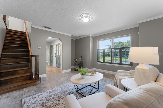 living room with crown molding, light hardwood / wood-style flooring, and a textured ceiling