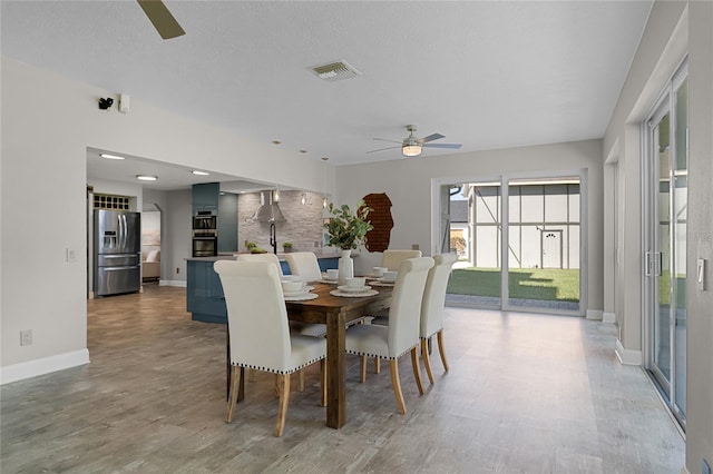 dining space with wood-type flooring and ceiling fan