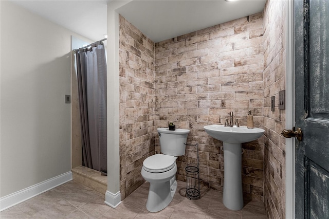 bathroom with tile patterned flooring, toilet, and a shower with curtain