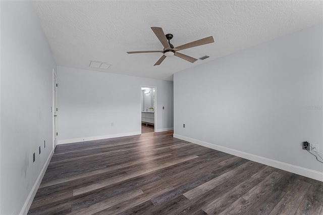 spare room featuring a textured ceiling, ceiling fan, and dark hardwood / wood-style floors