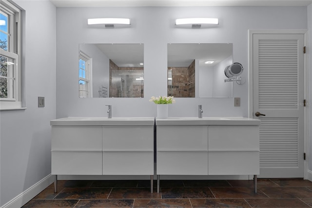 bathroom with vanity and tiled shower