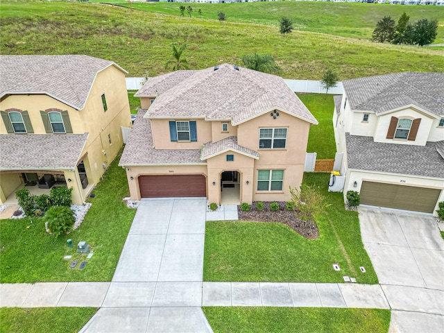 view of front of property featuring a front lawn and a garage