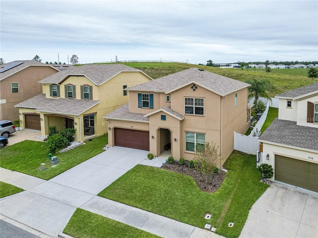 view of front of property with a front yard and a garage