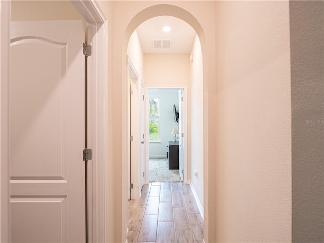 hall with light hardwood / wood-style floors