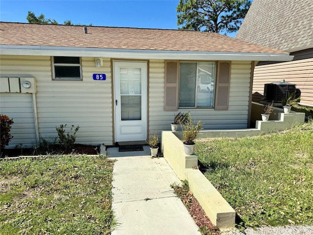 entrance to property featuring a yard