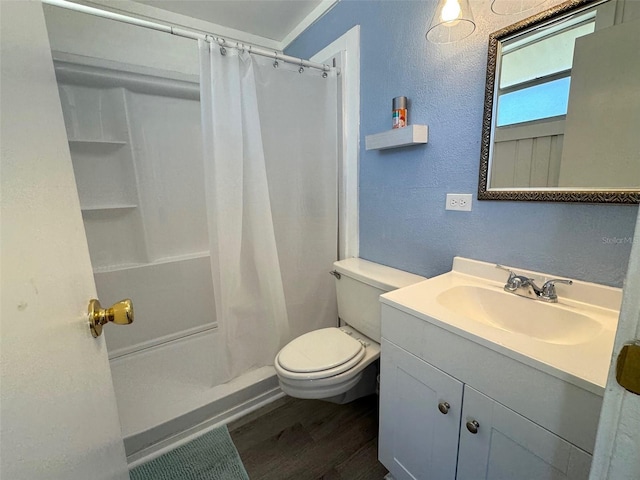 bathroom featuring vanity, curtained shower, wood-type flooring, and toilet