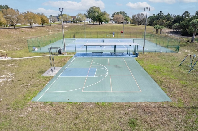 view of sport court featuring a yard